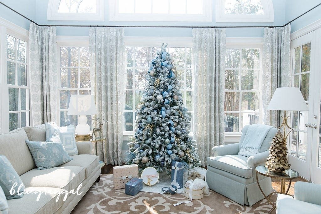 Blue Christmas tree decorations with blue Christmas ornaments and light blue ribbon and blue Christmas presents.